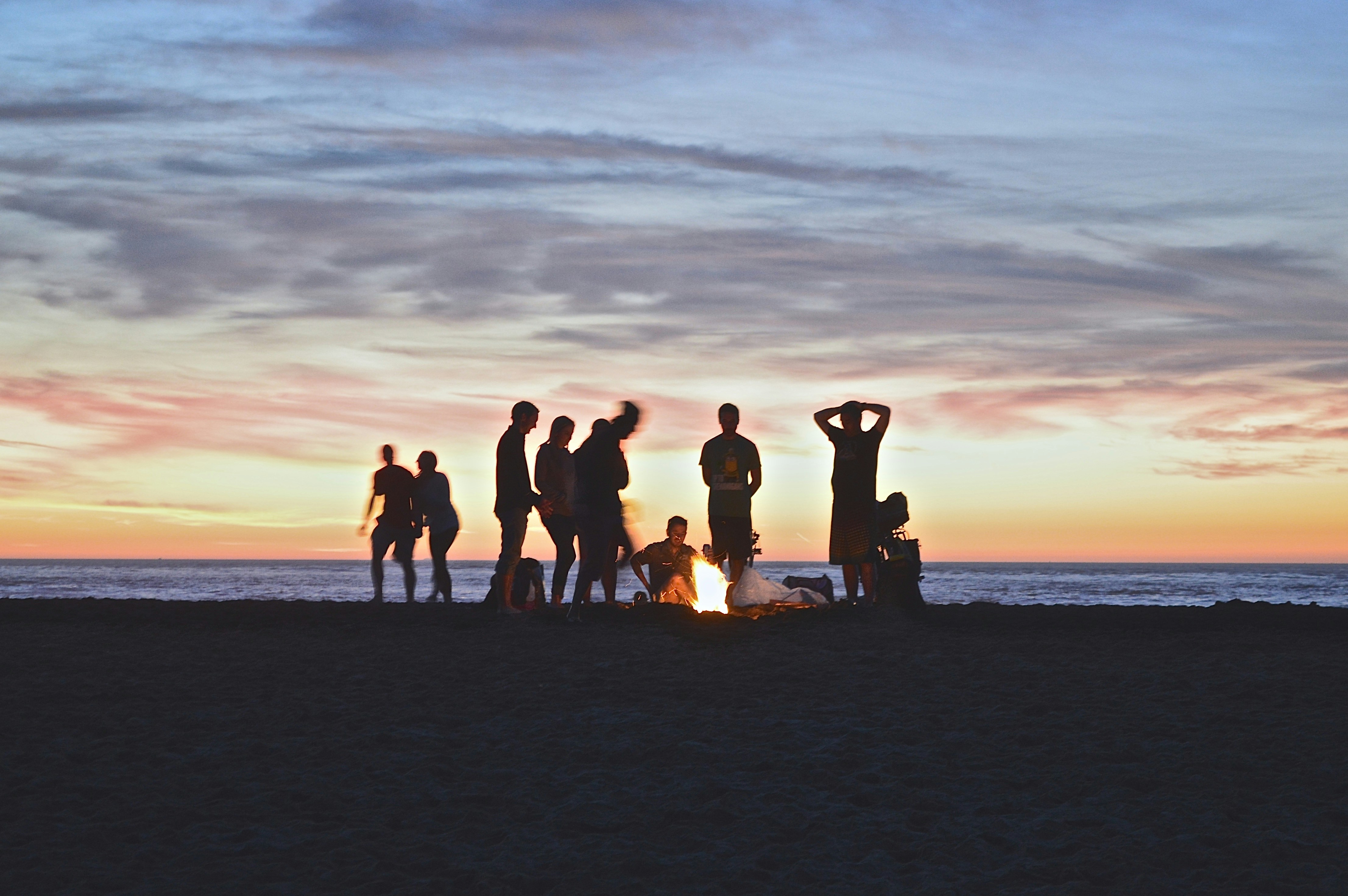 a group of people in the distance on the beach